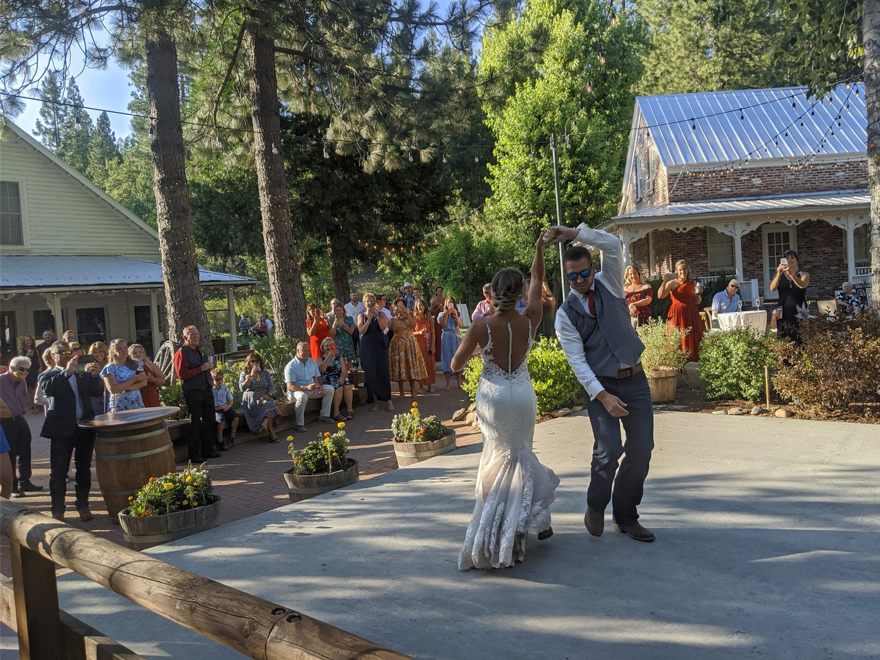 Scott spins Danielle during their first dance on the patio as guests film from the edge