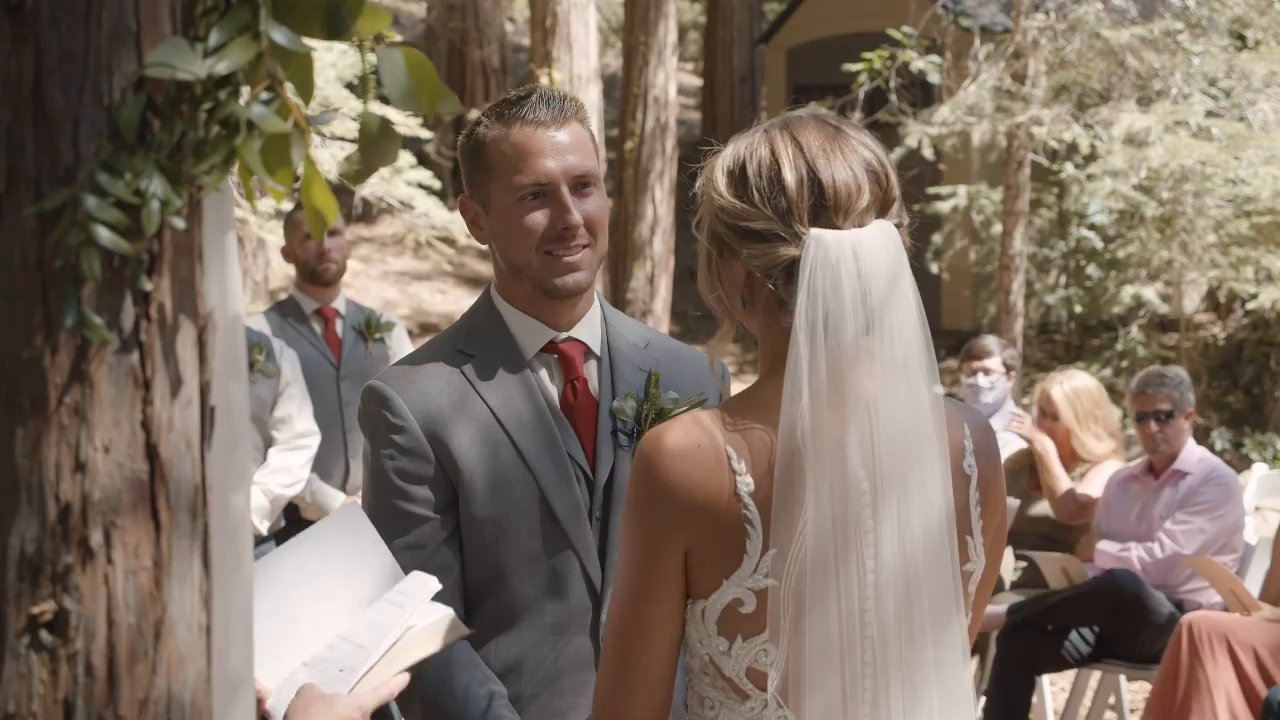 Scott beams at Danielle as the officiant reads.