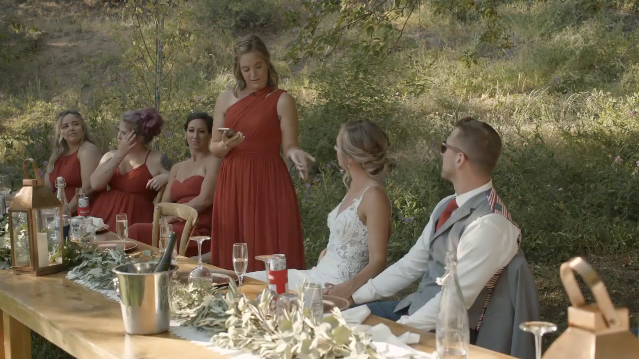 A bridesmaid in red gives her toast as Danielle and Scott listen.