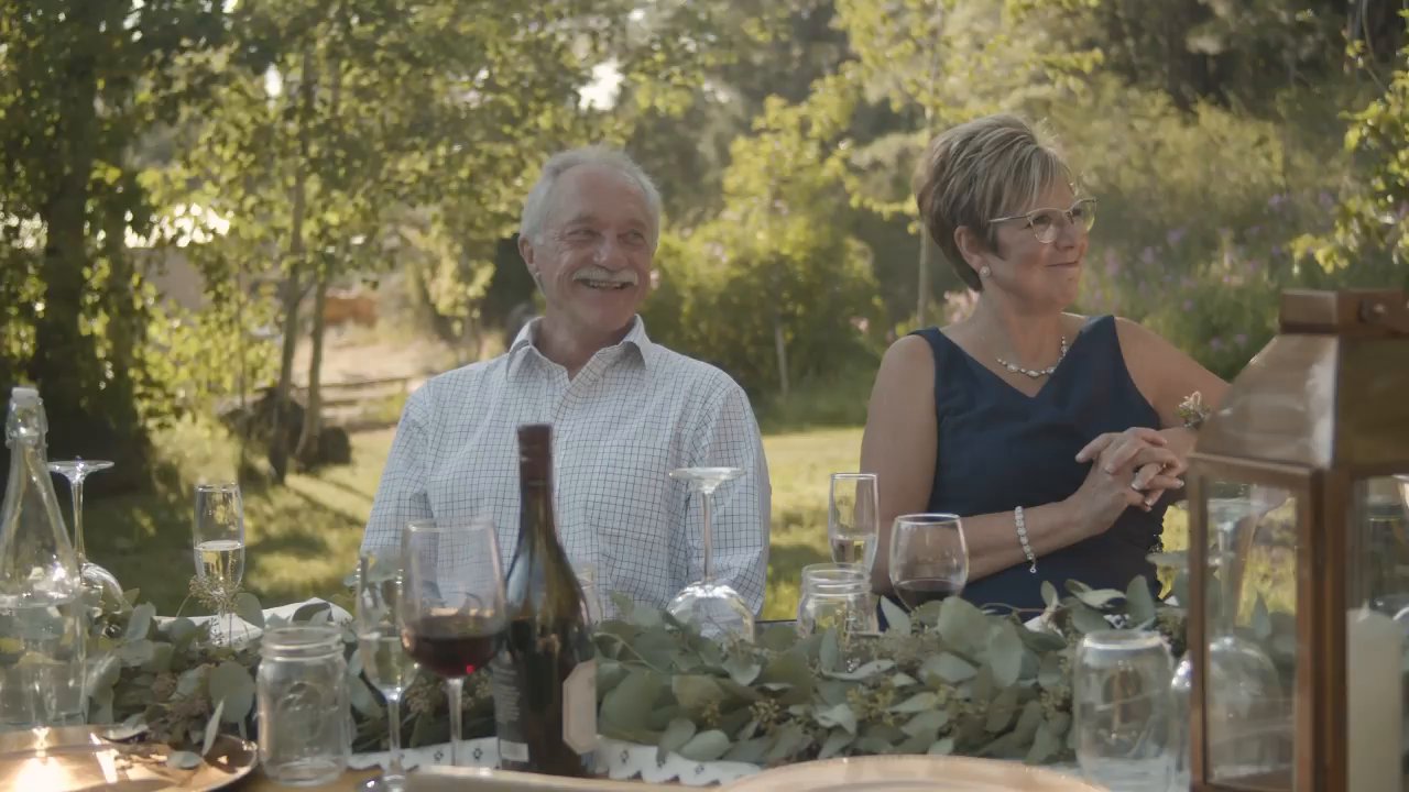 Parents smile at their table during the toasts.