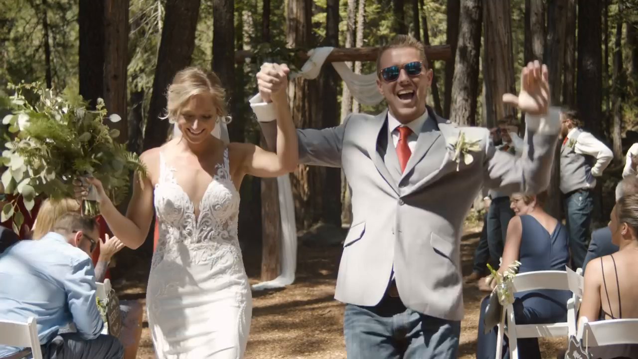 Scott pumps his fist and Danielle lifts her bouquet as they head up the aisle.
