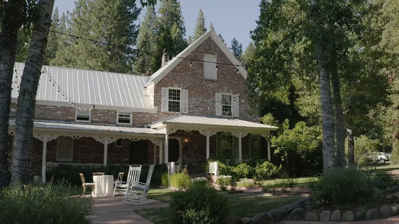 The brick farmhouse at Twenty Mile House with its white porch.