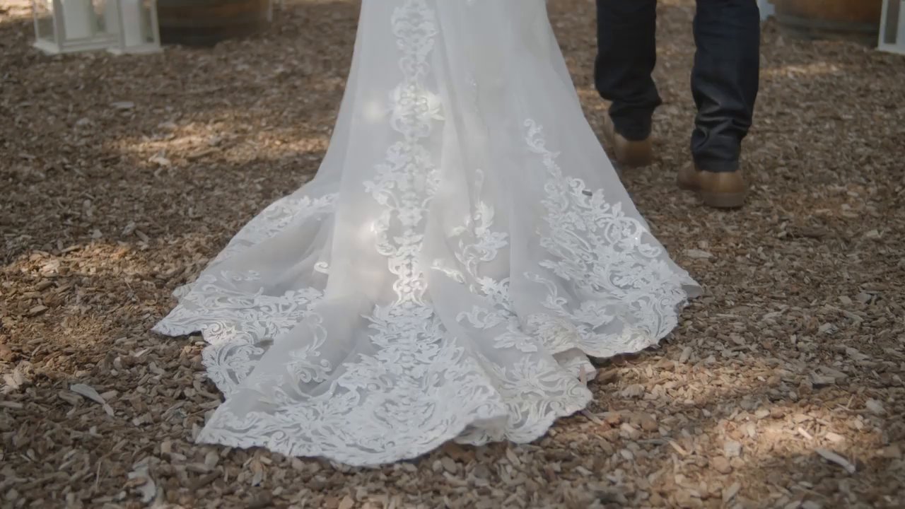 The long lace train of Danielle's gown spread over the forest floor.