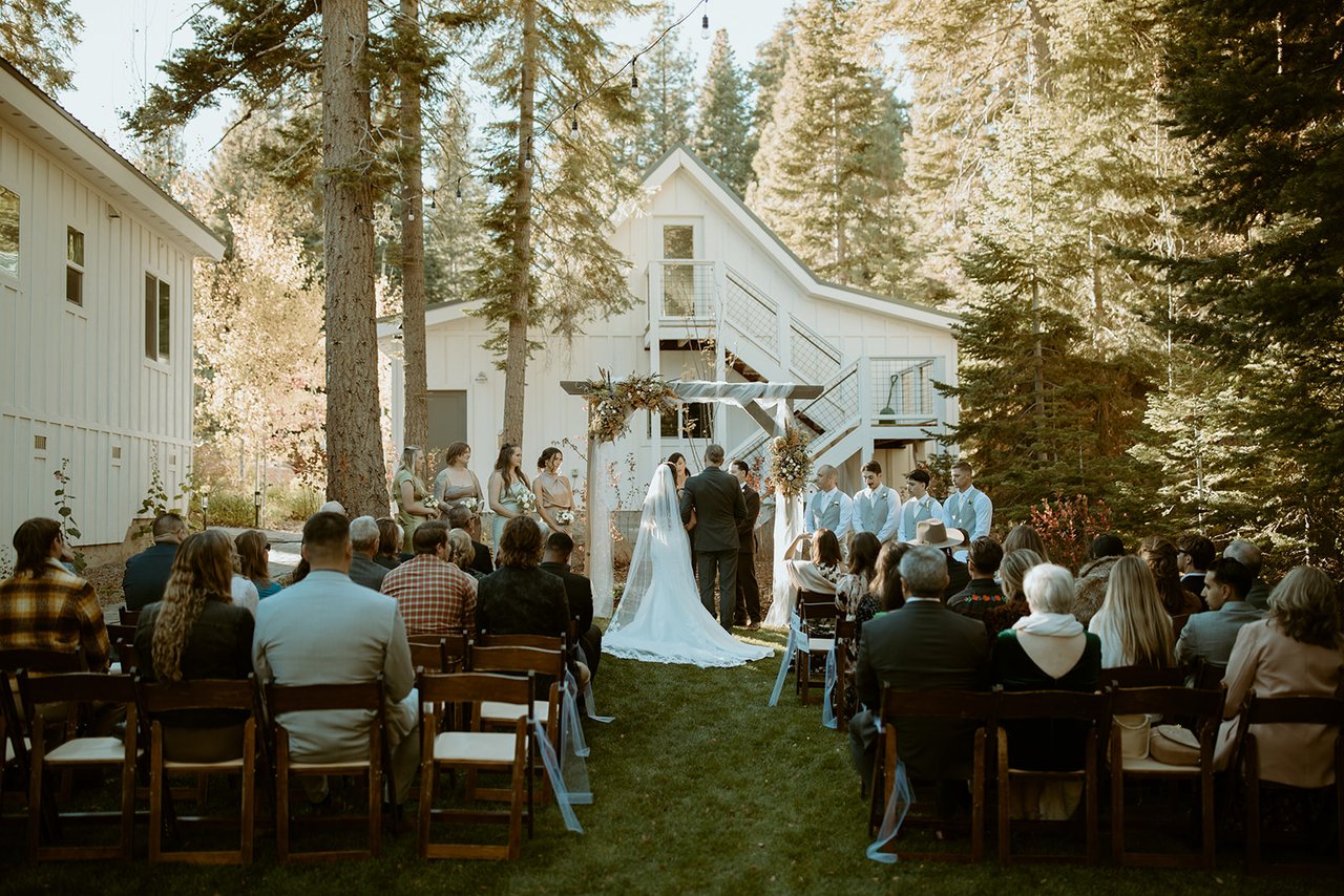 Guests watch the ceremony under the pines on the private estate