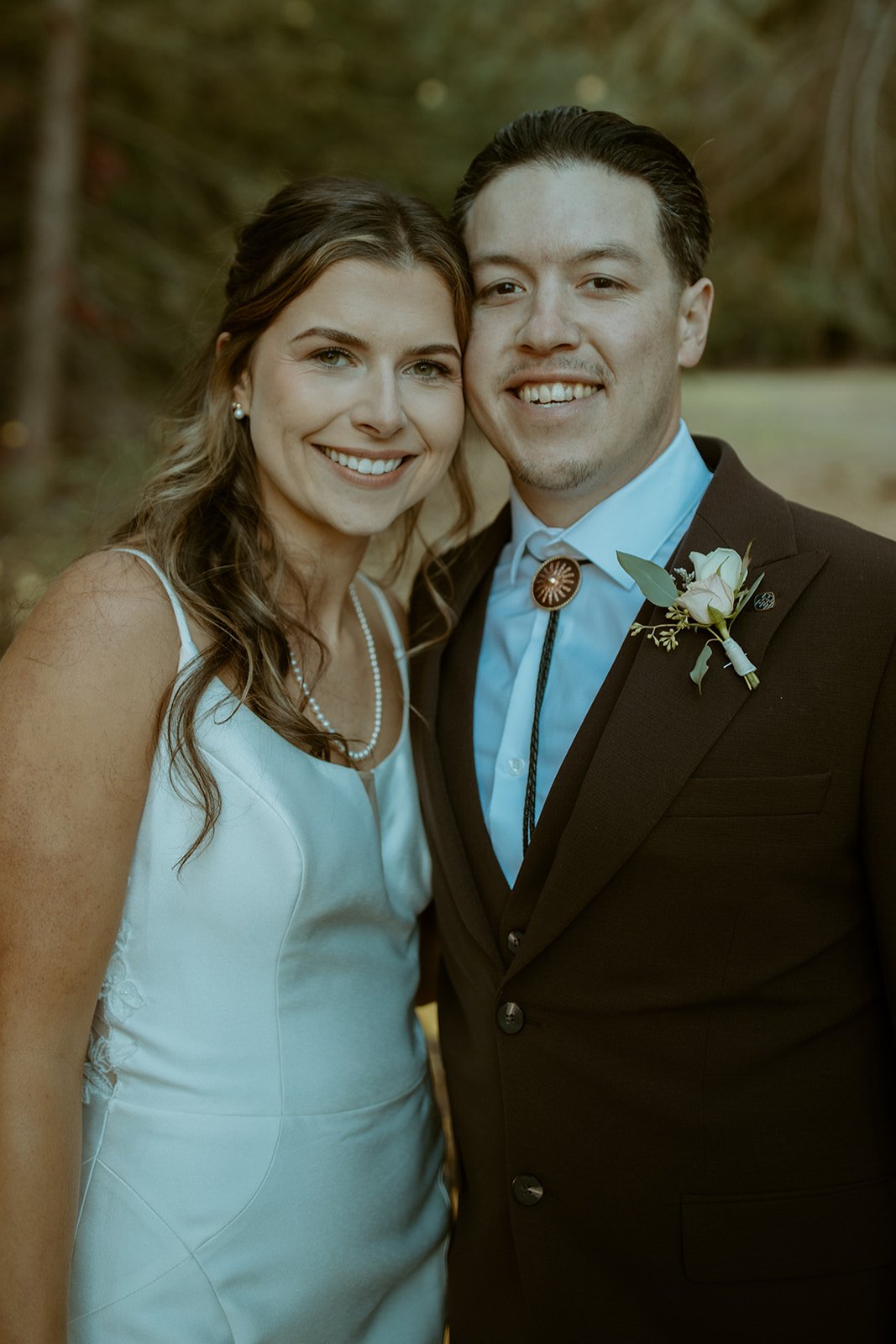Emily and Devin smile cheek to cheek