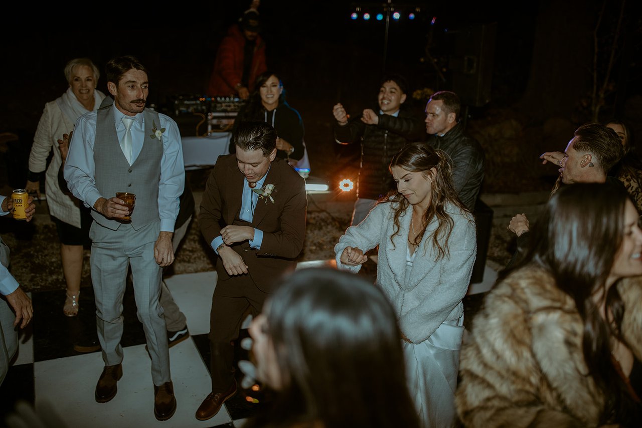 Emily and Devin dance with their friends on the checkered floor
