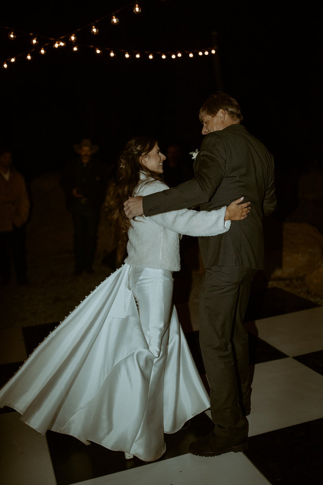 Emily's gown swirls as she dances with her dad