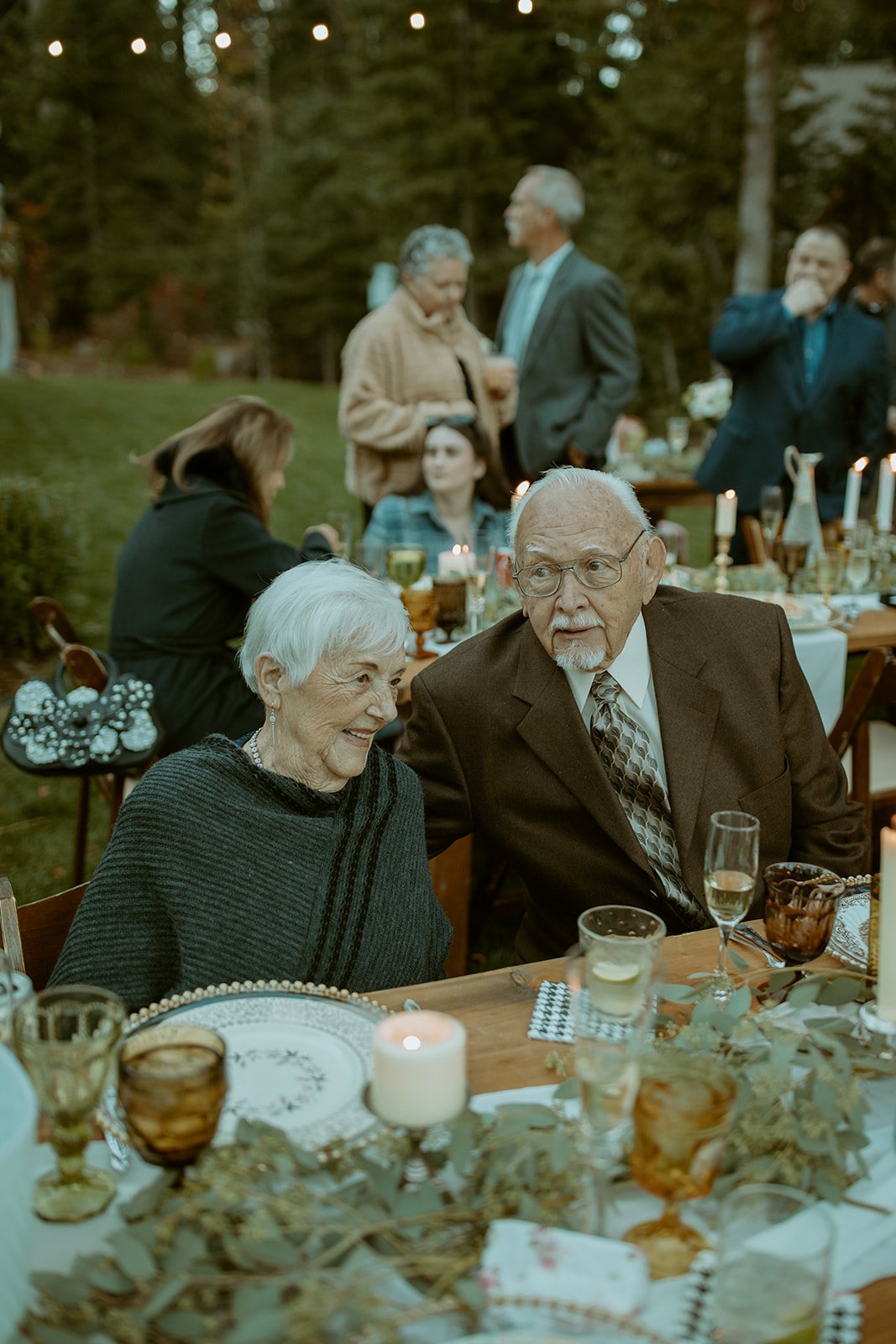An older couple shares a smile at the dinner table