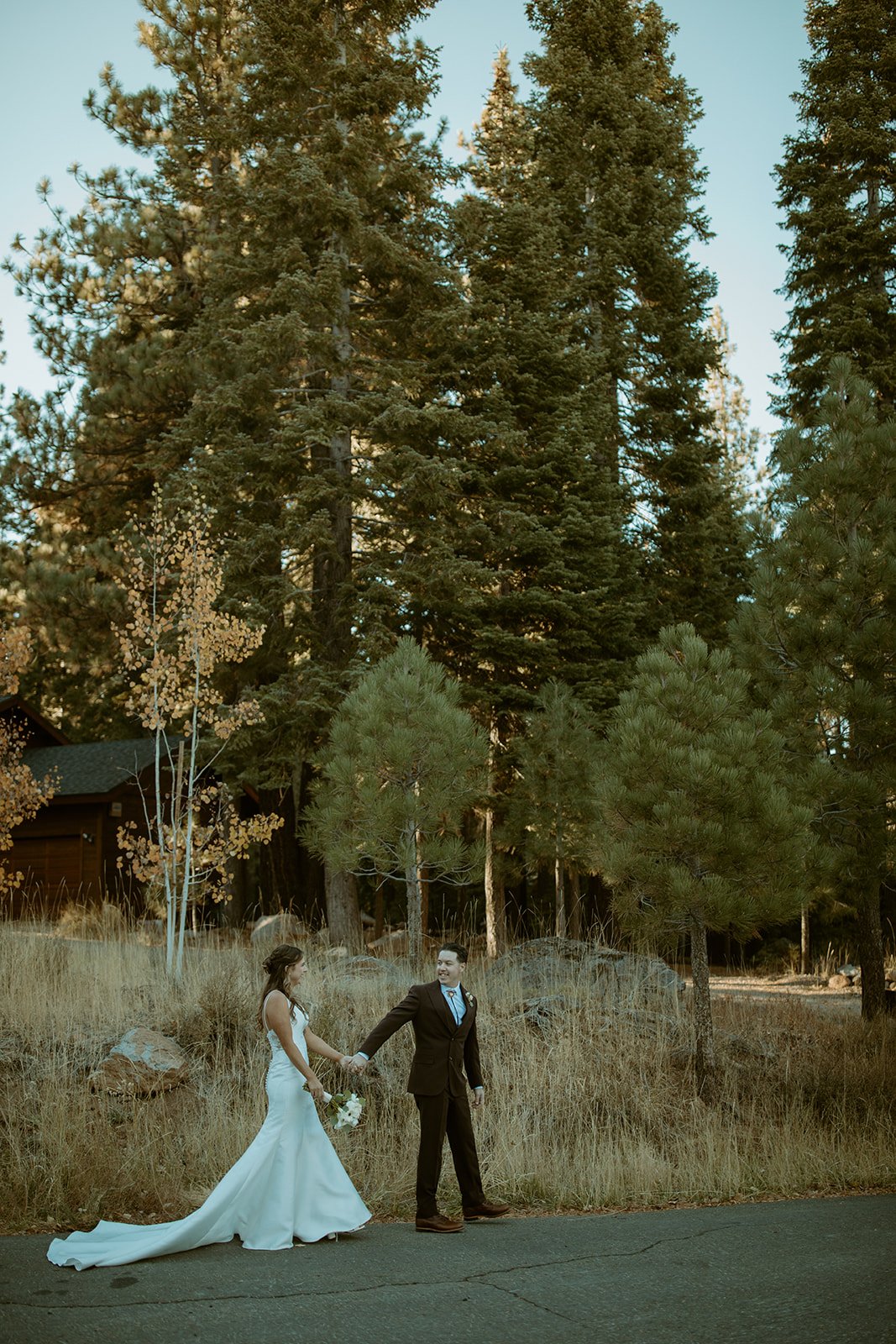 Emily leads Devin by the hand along the meadow road