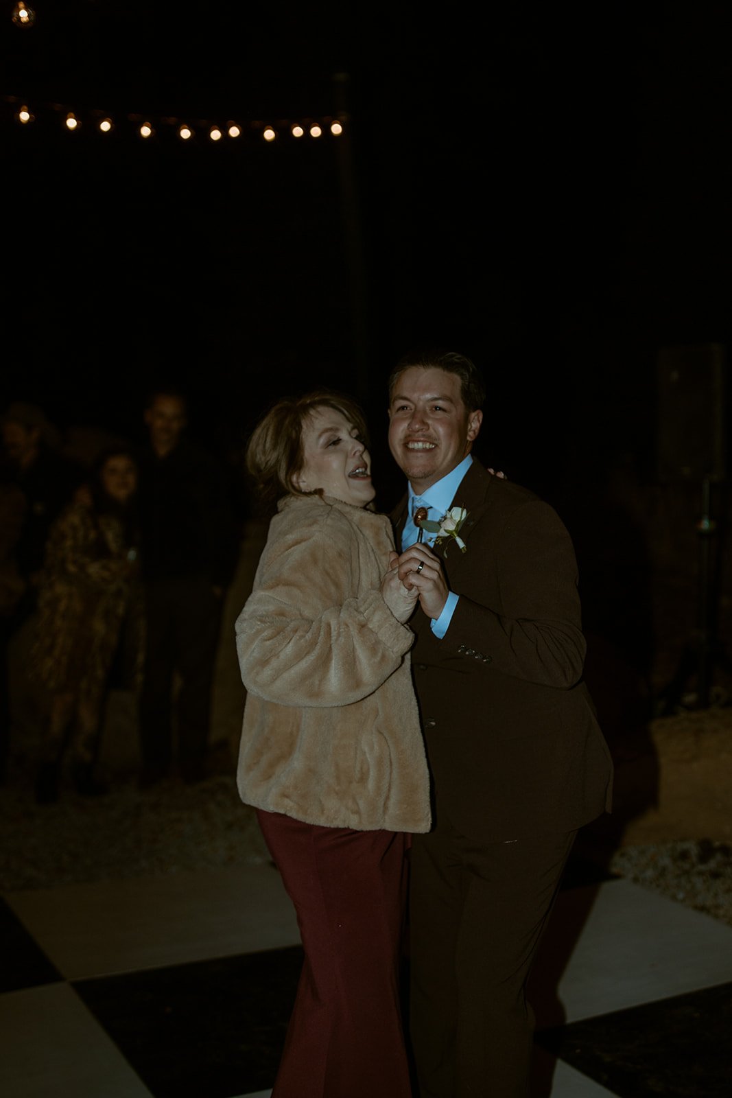 Devin and his mom smile during their dance
