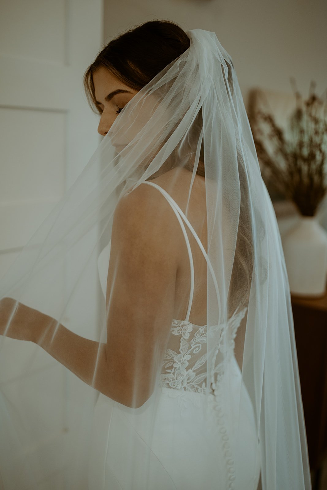 Emily's veil drifts across her face