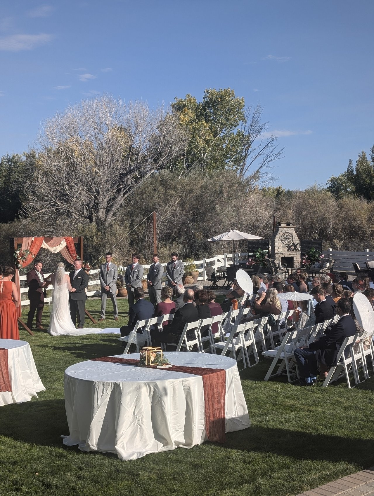 Emily and Logan say their vows under the autumn trees