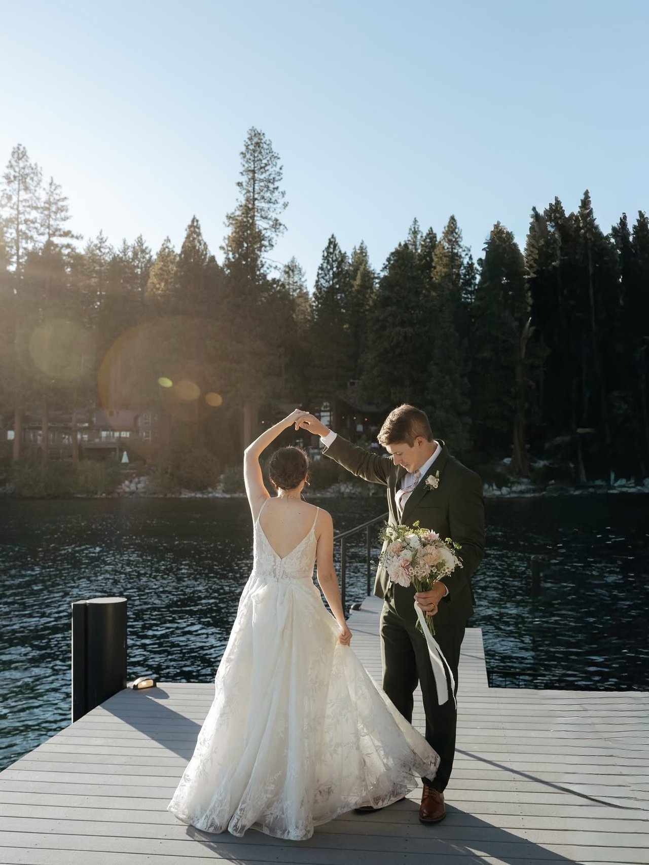 Emma and Jackson twirl on the dock by the lake