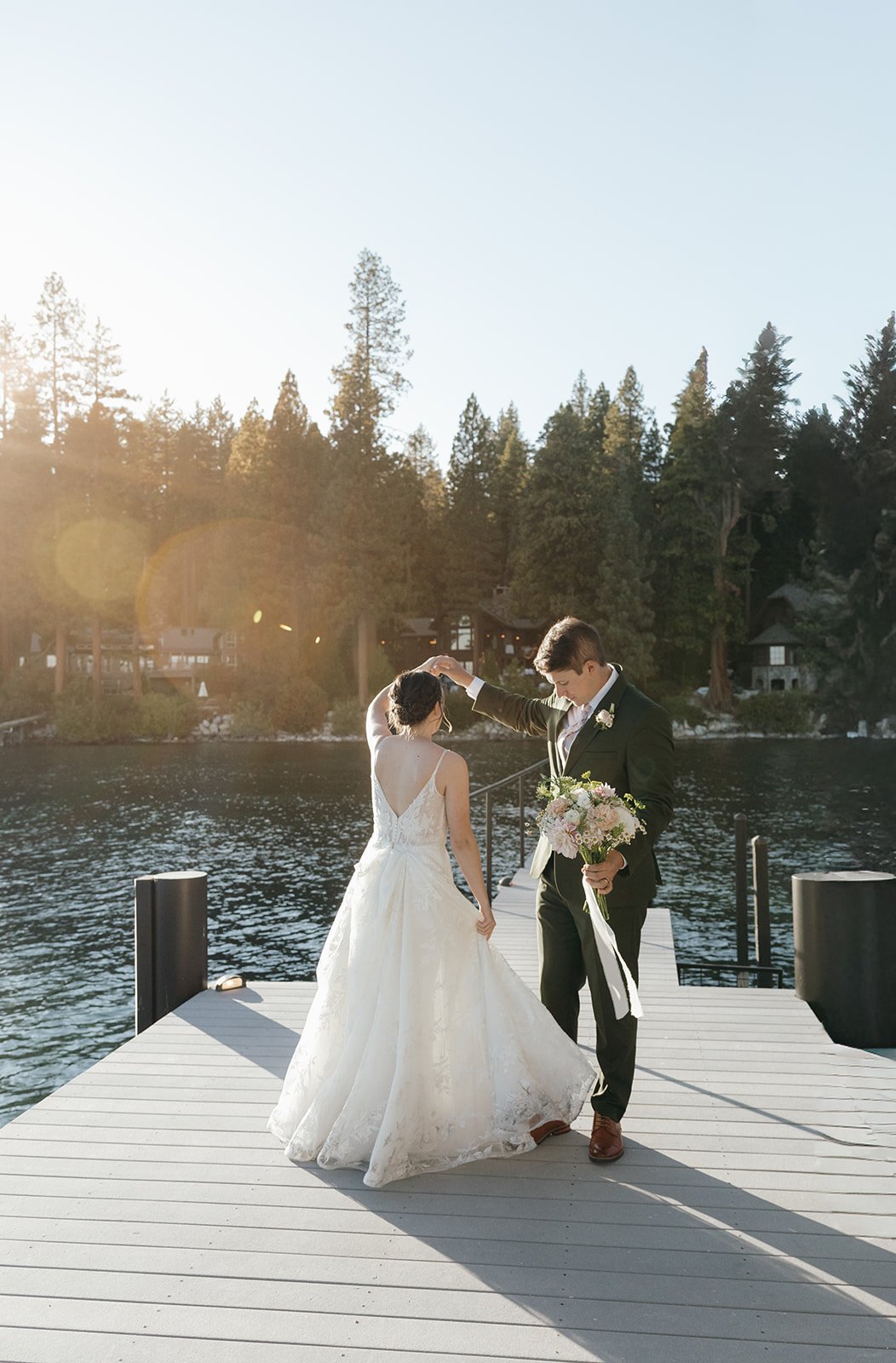Emma's gown swings out as Jackson twirls her on the dock