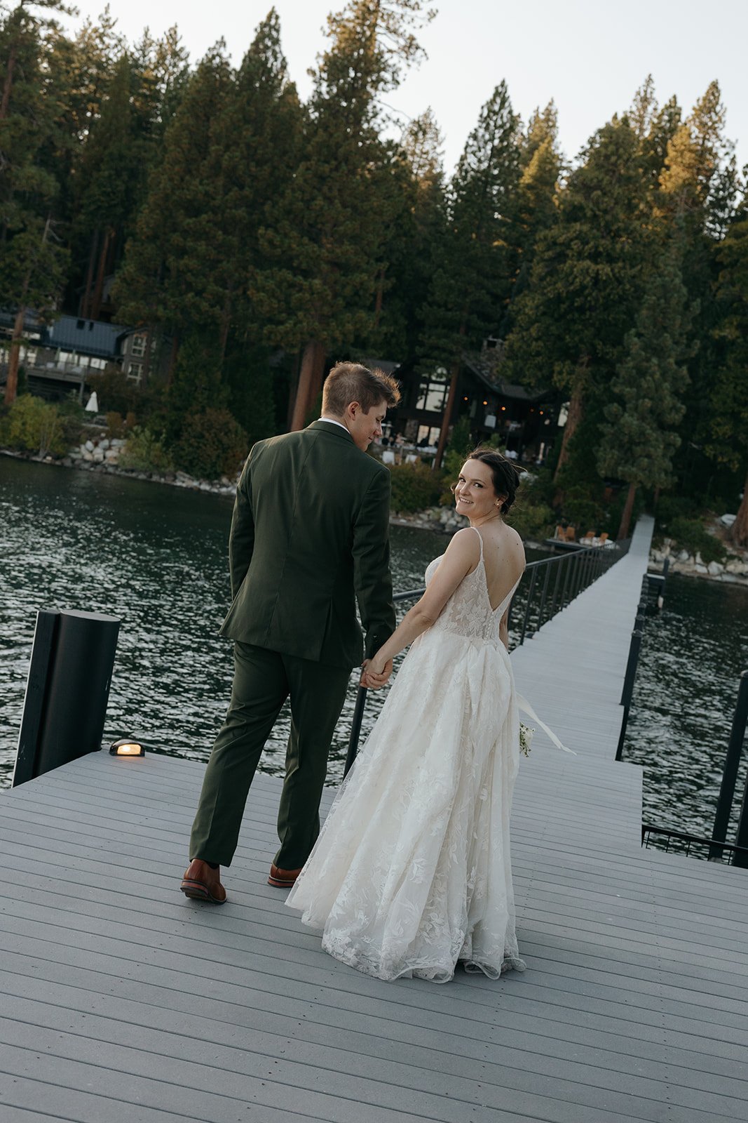 Emma looks back over her shoulder as she and Jackson walk down the dock
