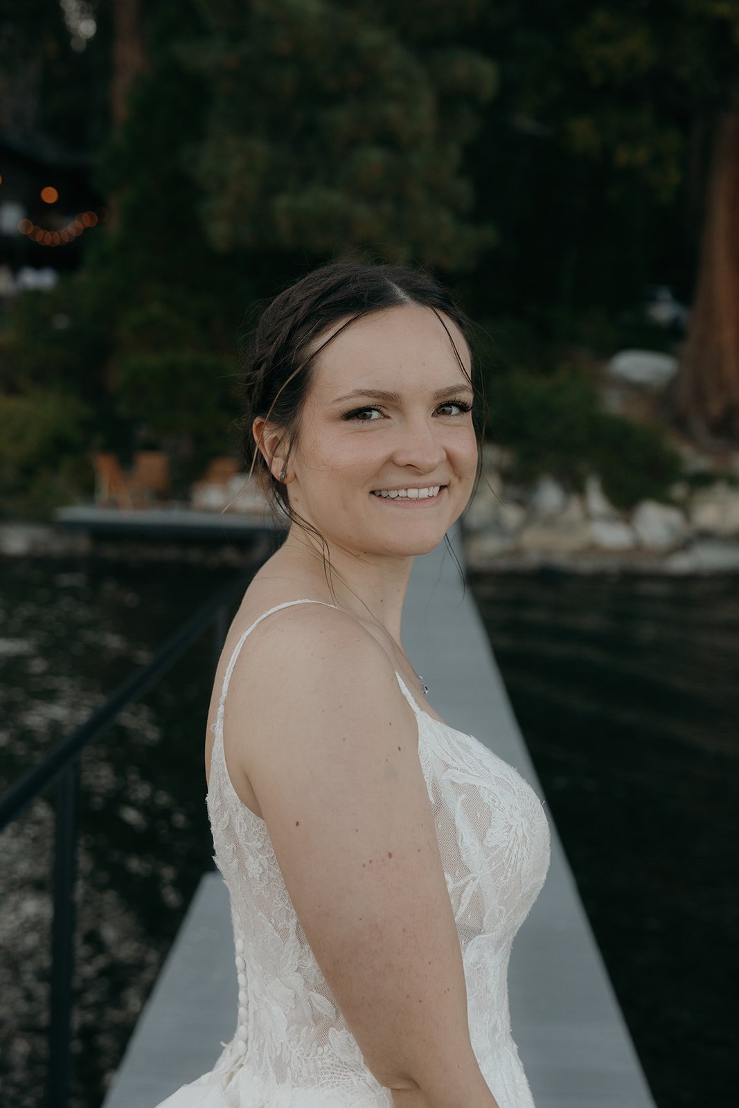 Emma smiles over her shoulder on the pier at dusk