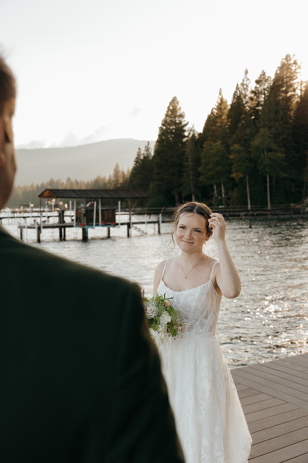 Emma laughs and touches her hair as she walks toward Jackson on the dock