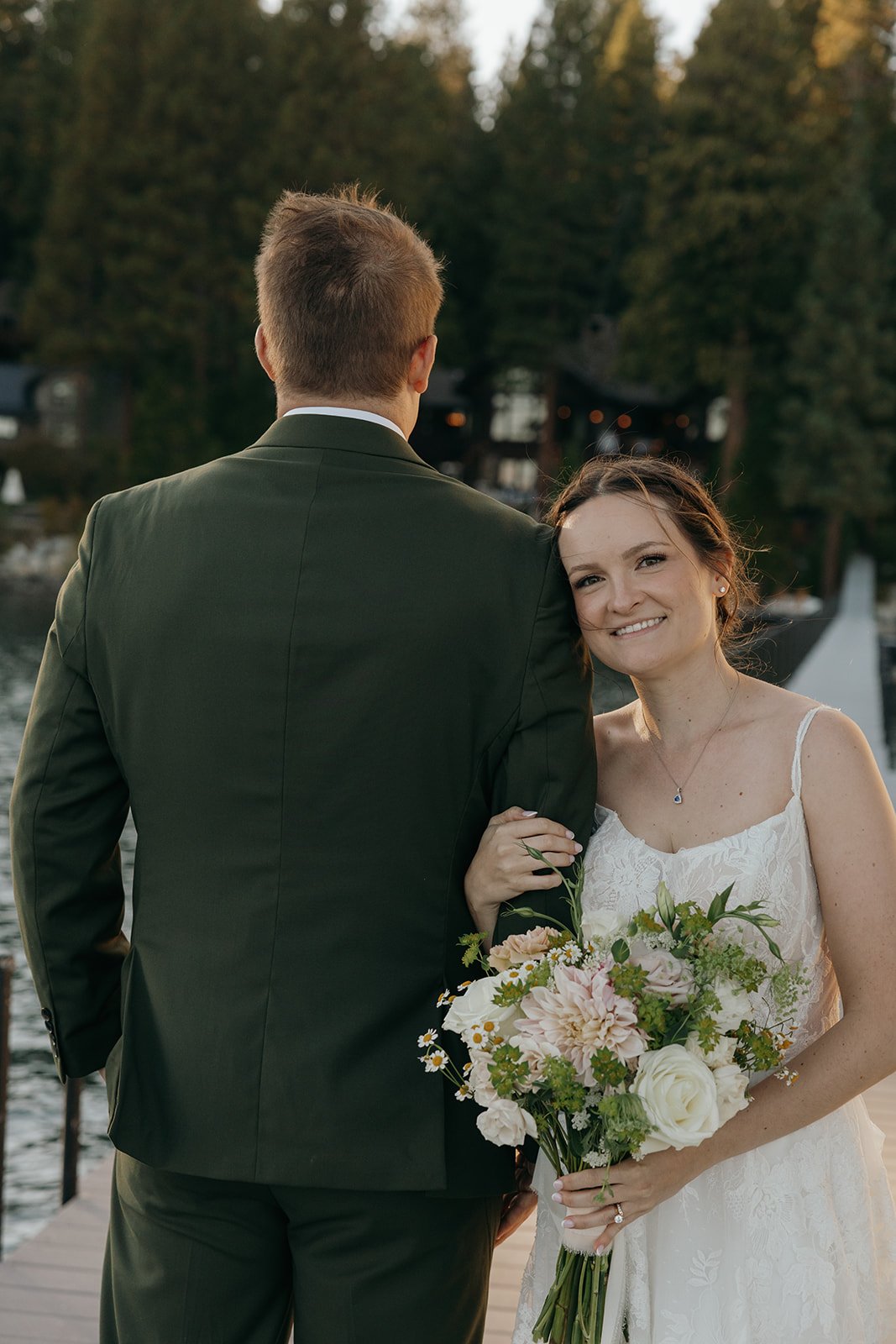 Emma smiles at the camera from Jackson's side on the dock