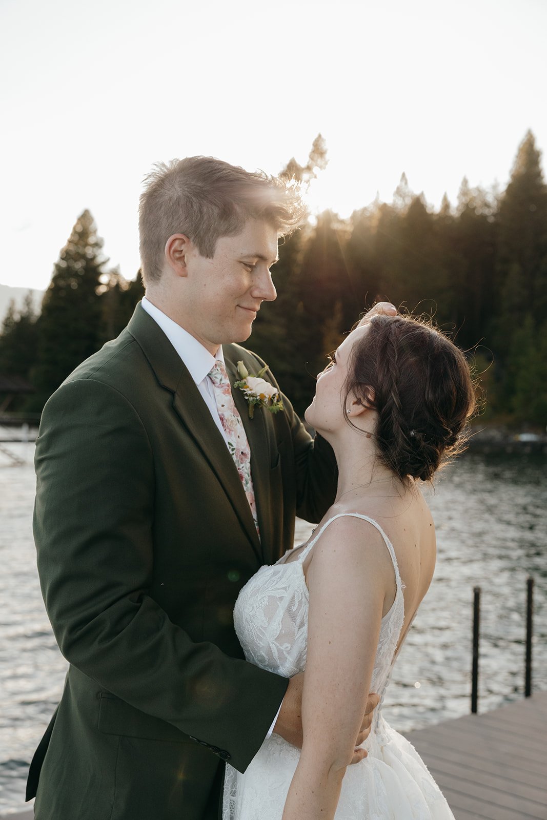 Emma looks up at Jackson as he smiles down at her in the golden light