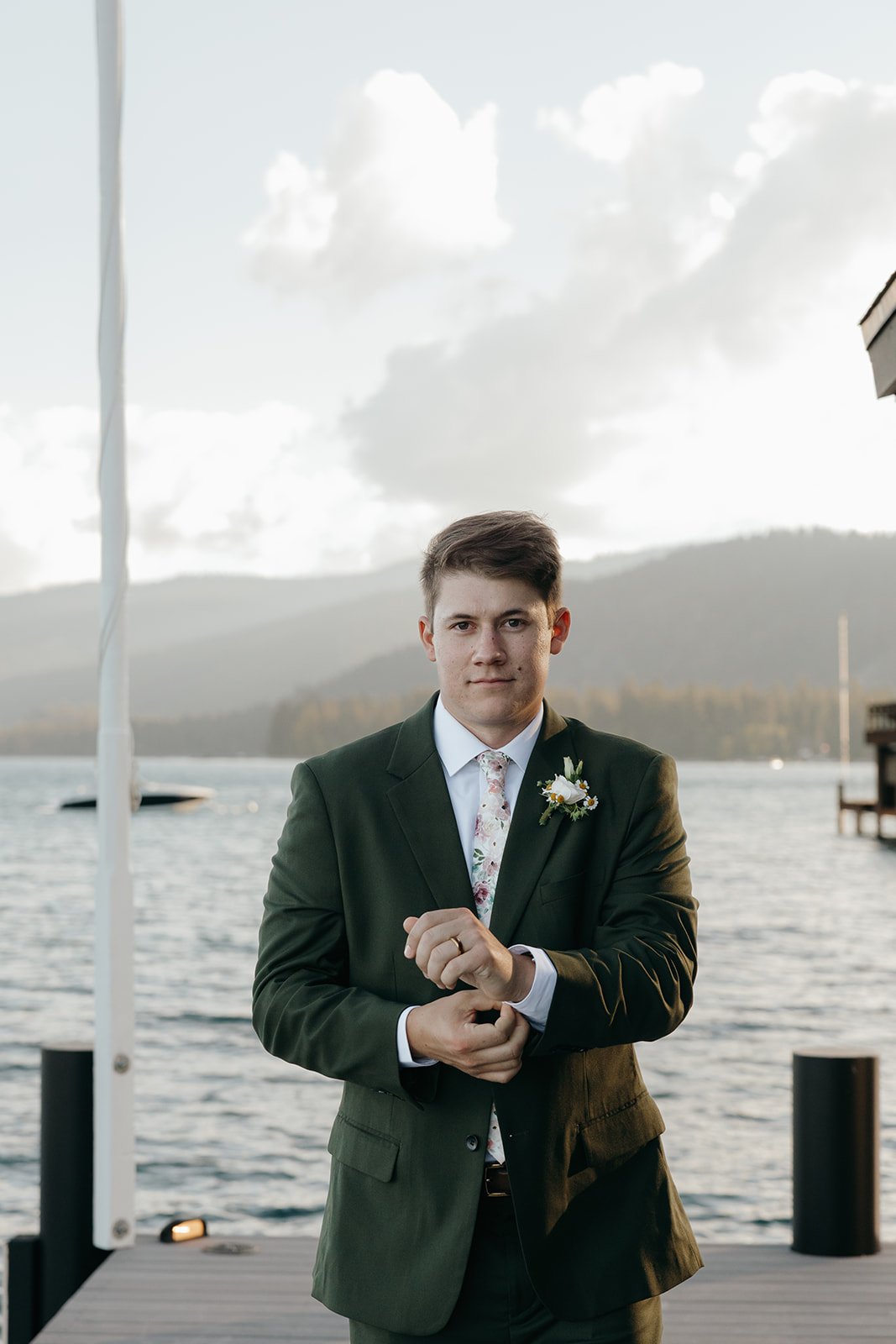 A portrait of Jackson in his green suit by the lake