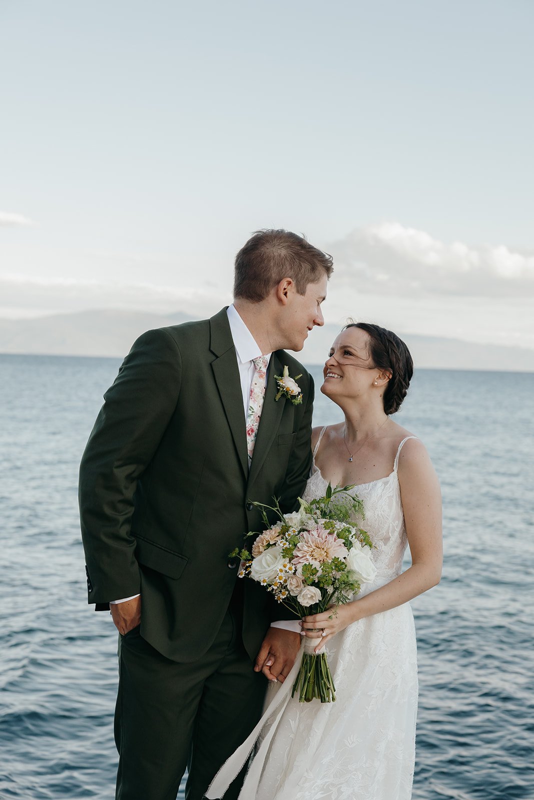 Emma and Jackson laugh nose to nose on the pier