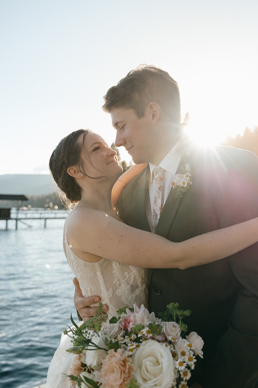 Emma and Jackson hold each other close in the low sun over the lake