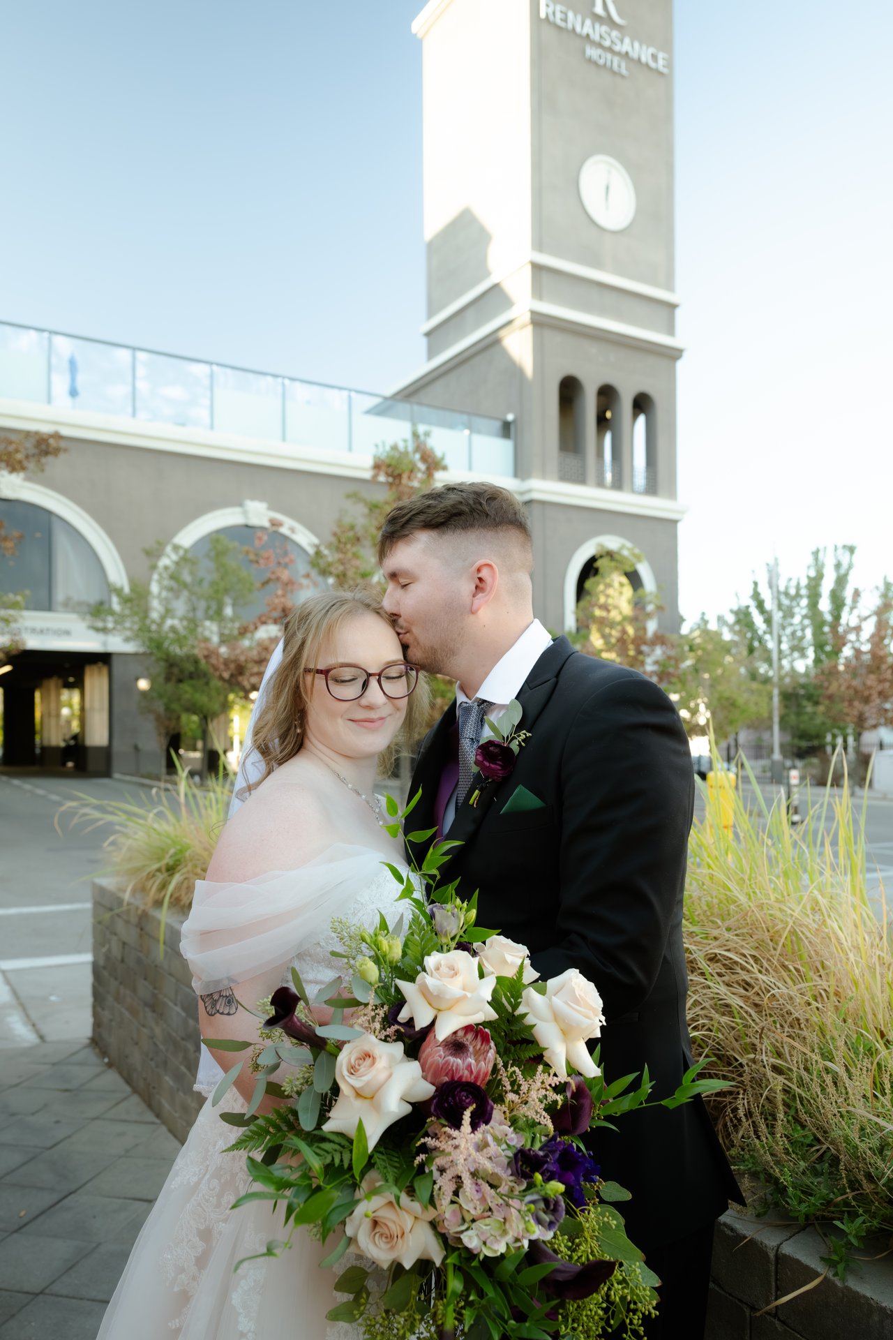 Zen kisses Hailey's temple under the clock tower