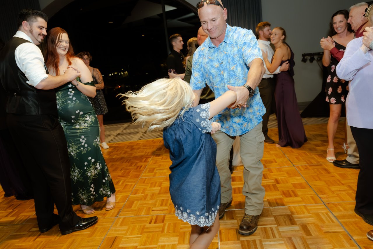 A little girl spins on the dance floor
