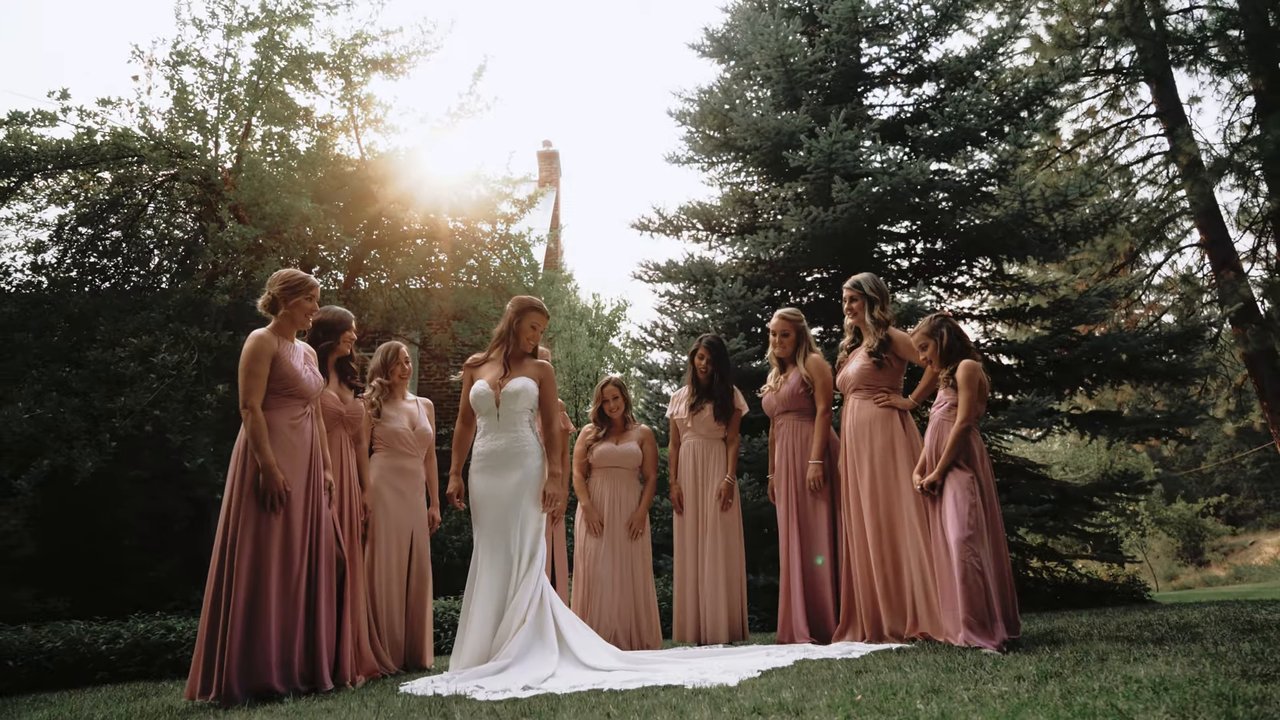 Jen stands with her bridesmaids as the sun breaks through the pines