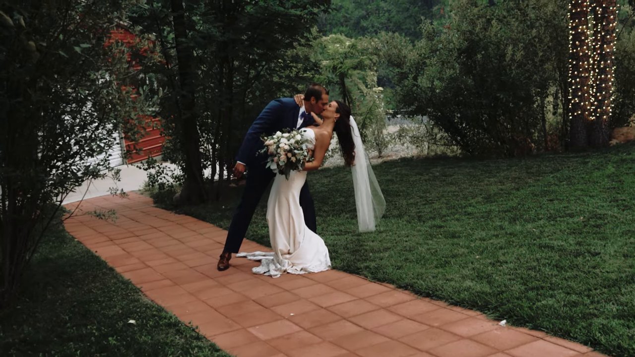 Wes dips Jen for a kiss on the garden path