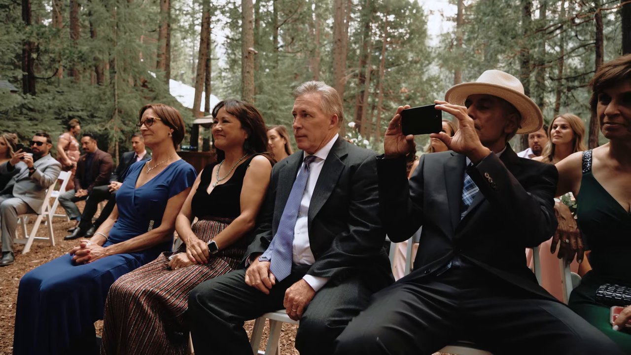 Guests watch from their seats in the pines as the ceremony begins
