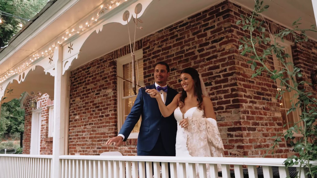 Jen and Wes ring the bell on the lodge porch