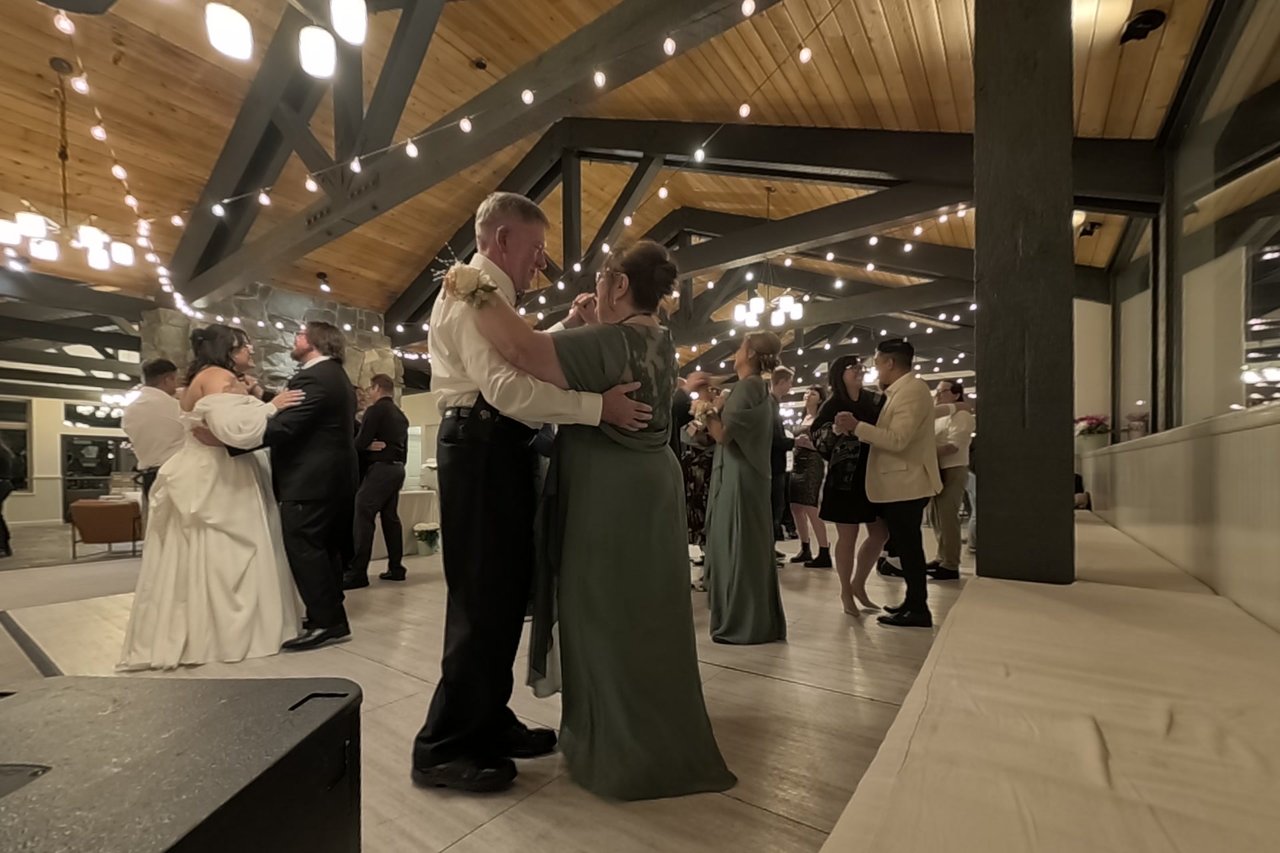 Couples fill the floor for the anniversary dance, Jericha and George among them