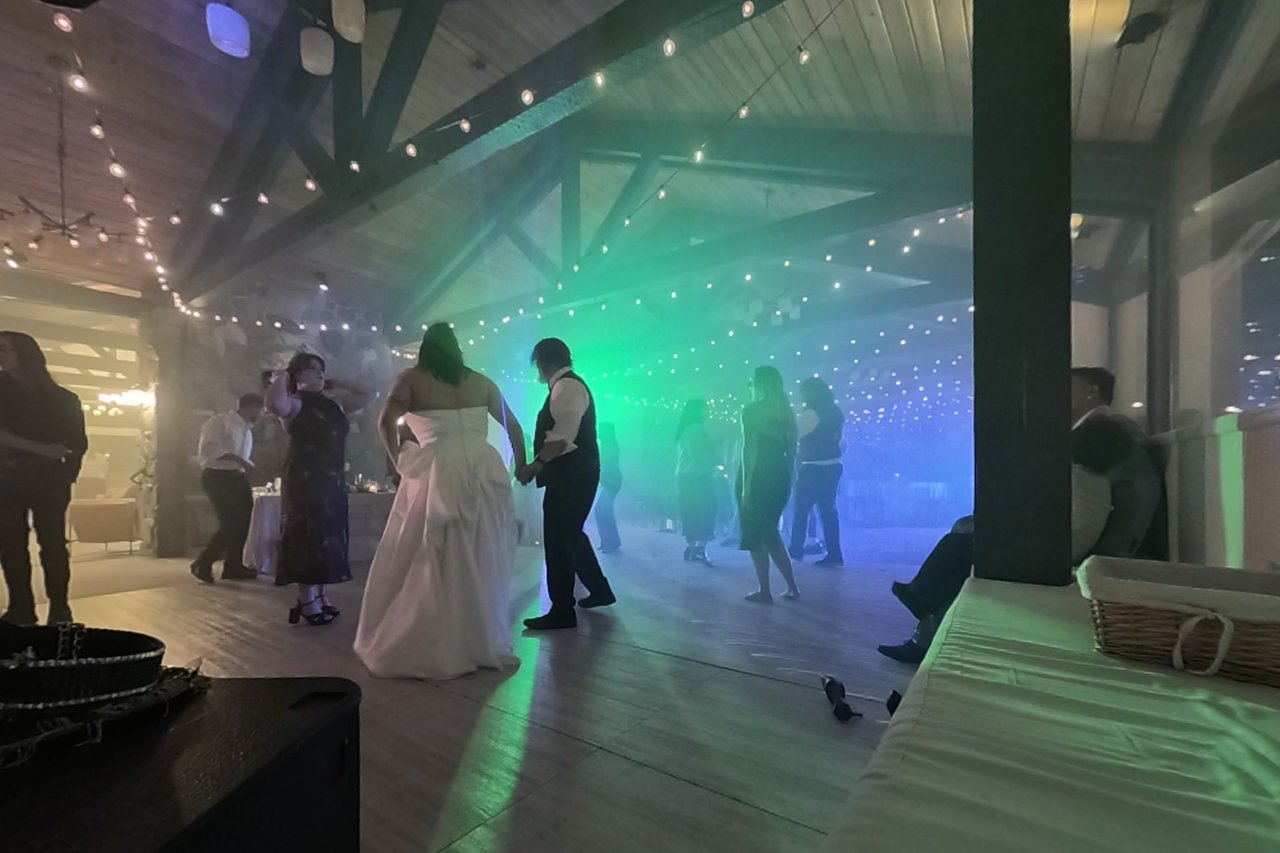 Jericha and George dance hand in hand in green light