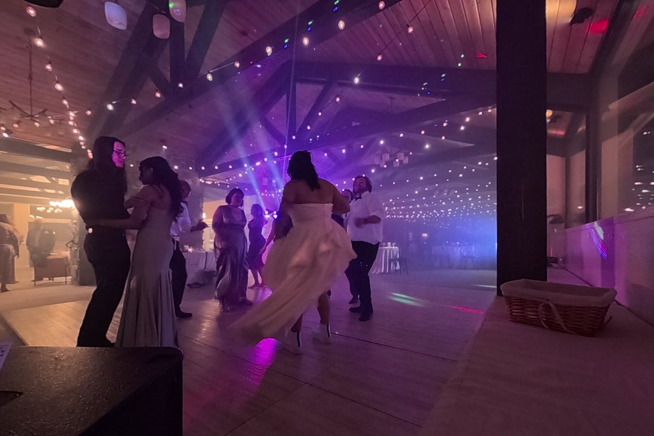 Jericha twirls her dress in purple light and haze on the dance floor