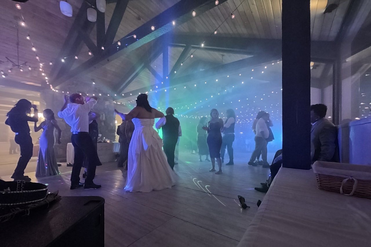 Jericha dances in the middle of the floor under green and blue beams