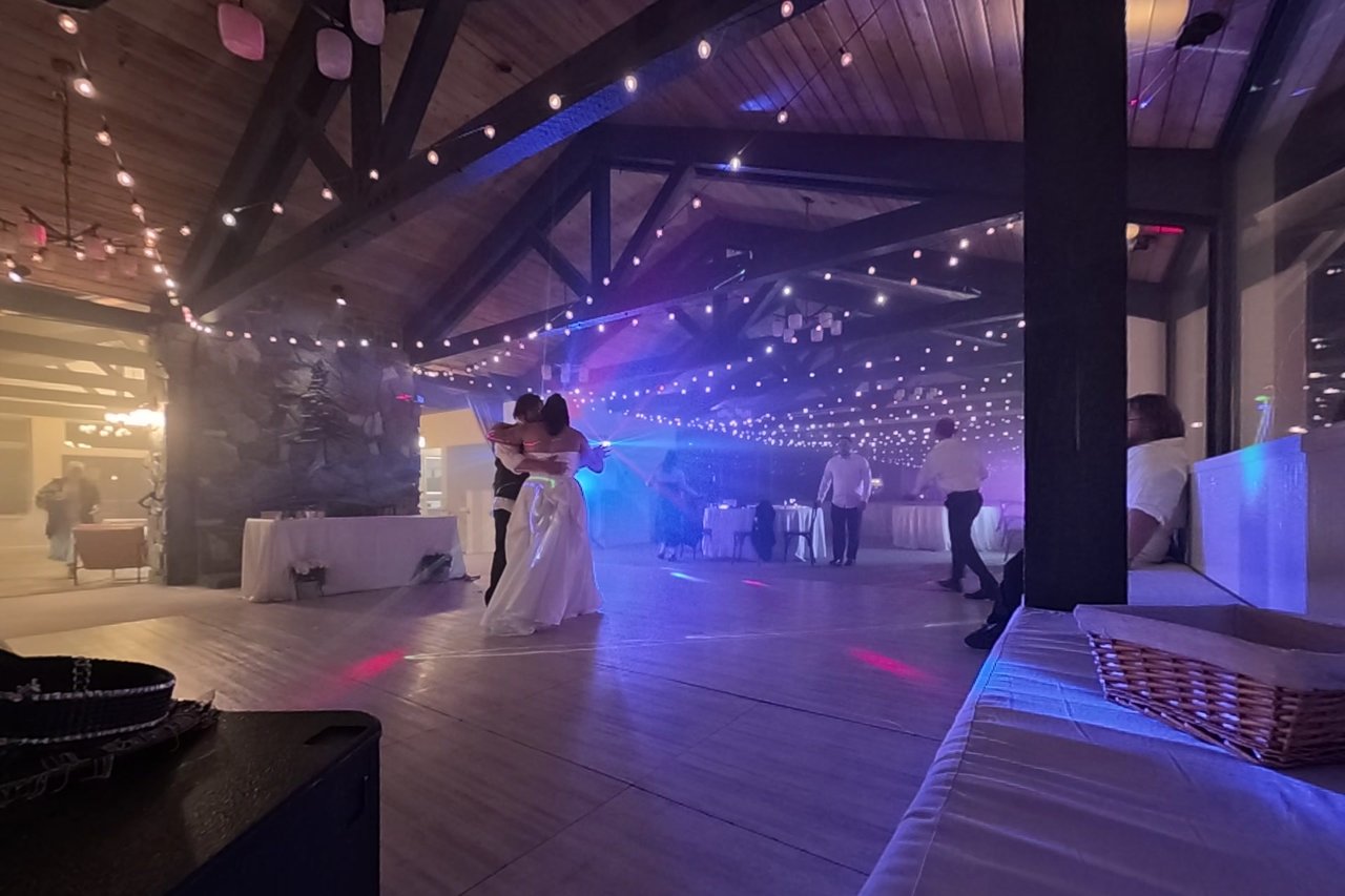 Jericha and George hold each other close in purple and blue light