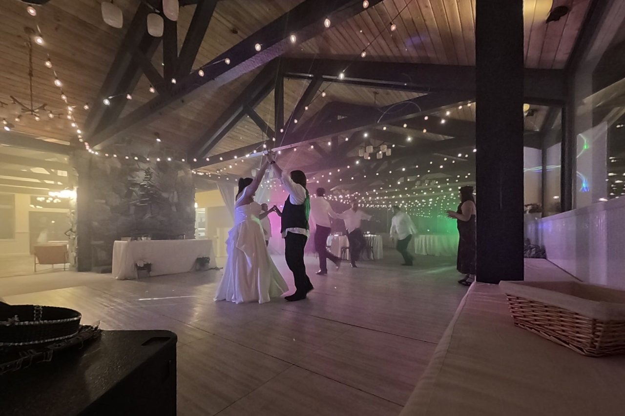 George twirls Jericha under the string lights