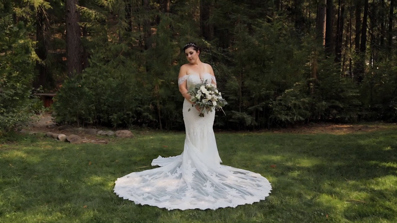 Jessie holds her bouquet in the forest at Twenty Mile House