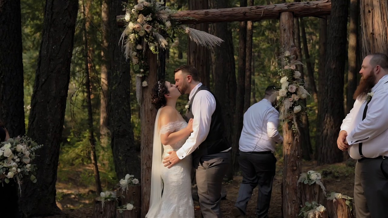 Jessie and Jeff share their first kiss as a married couple at the arch