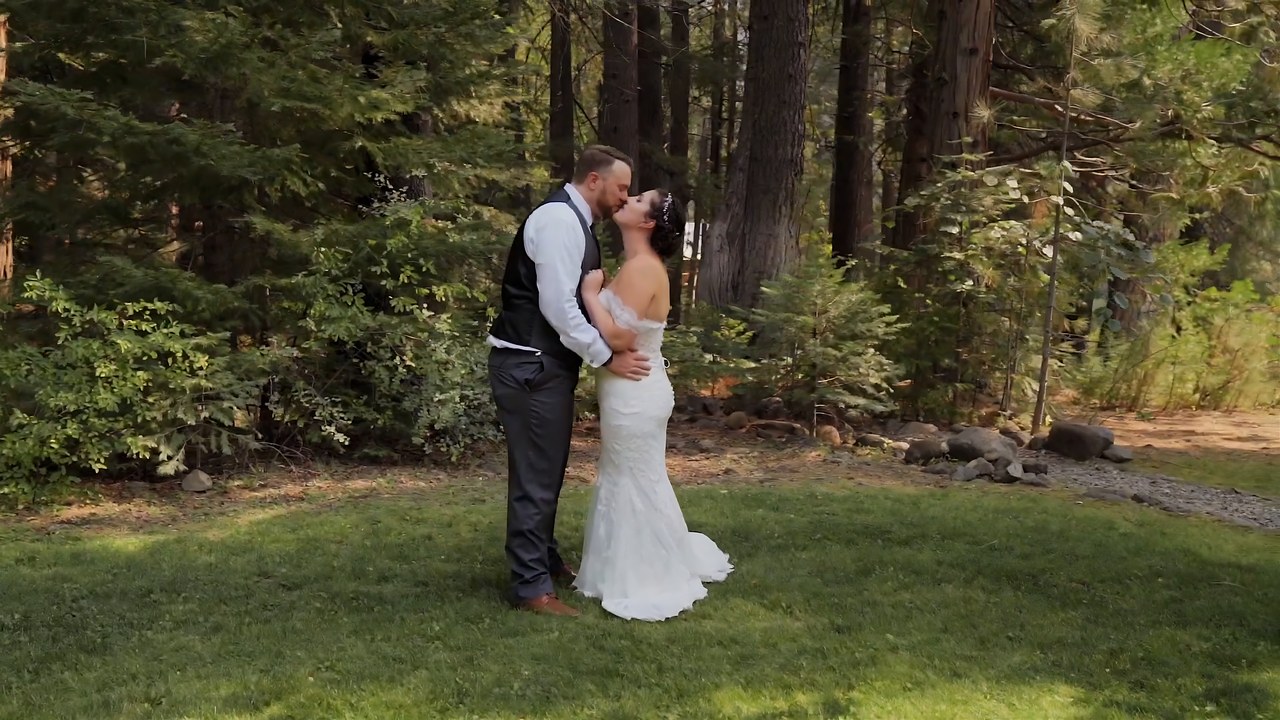 Jessie and Jeff share a kiss among the tall pines before the ceremony