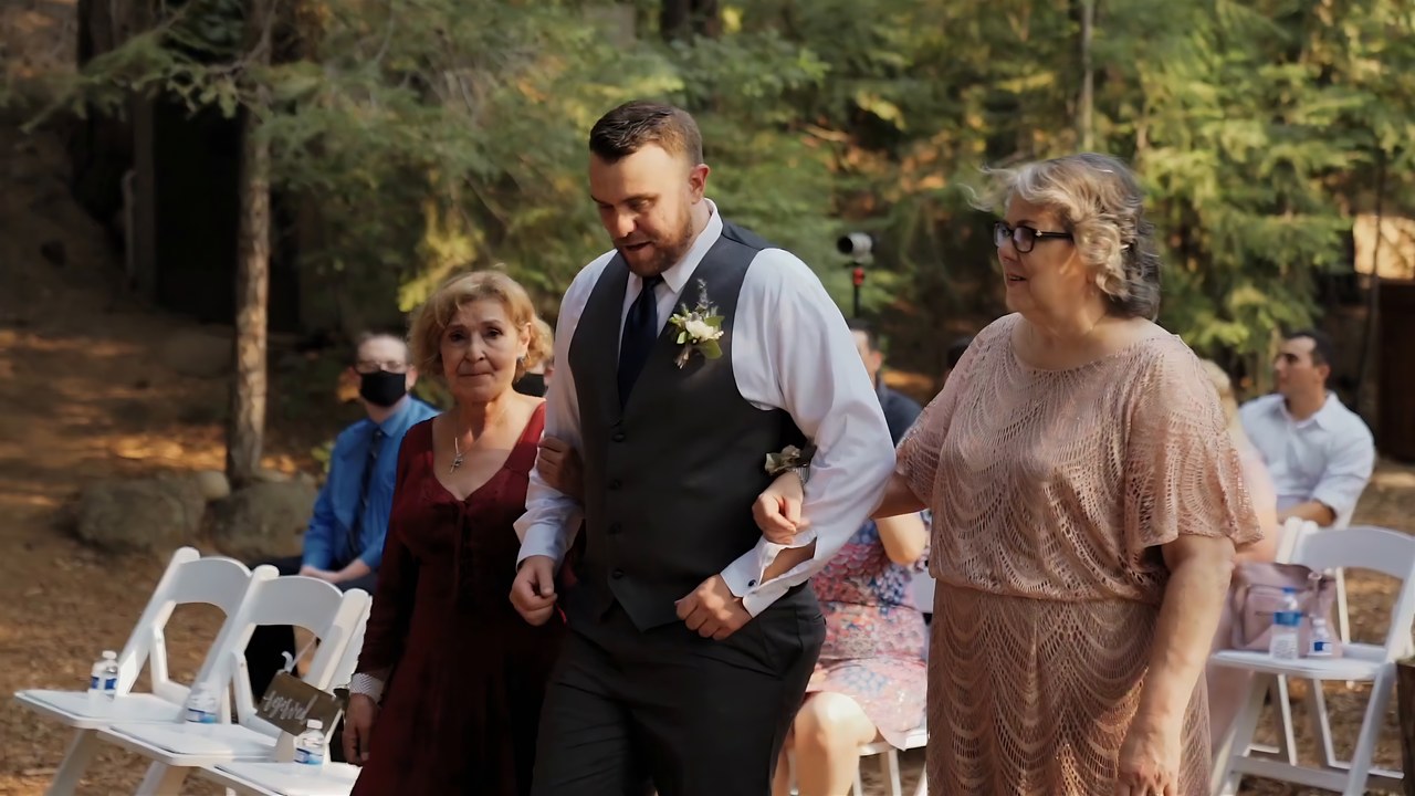 Jeff walks a family member down the aisle in the forest