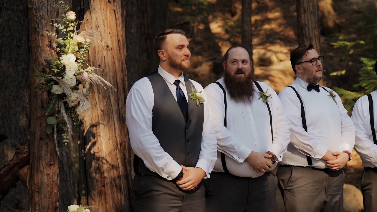 Jeff and his groomsmen wait at the altar among the pines