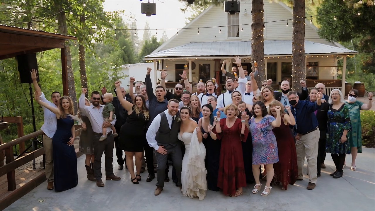 The group photo with every guest in front of the brick house
