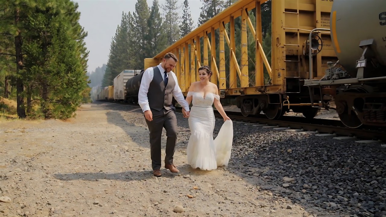 Jessie and Jeff walk past the old yellow train cars