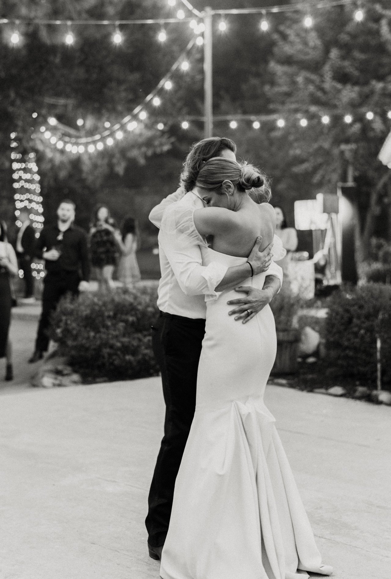 Joan and Kyle share their first dance, in black and white