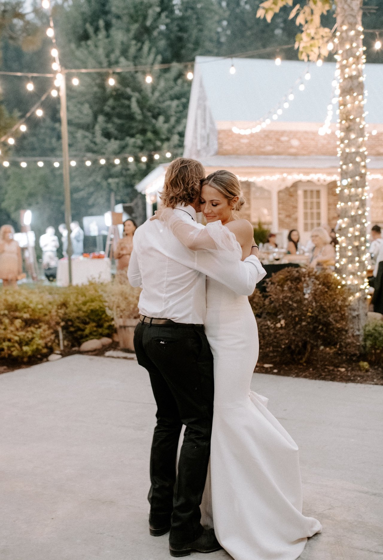 Joan and Kyle share their first dance under the string lights at Twenty Mile House