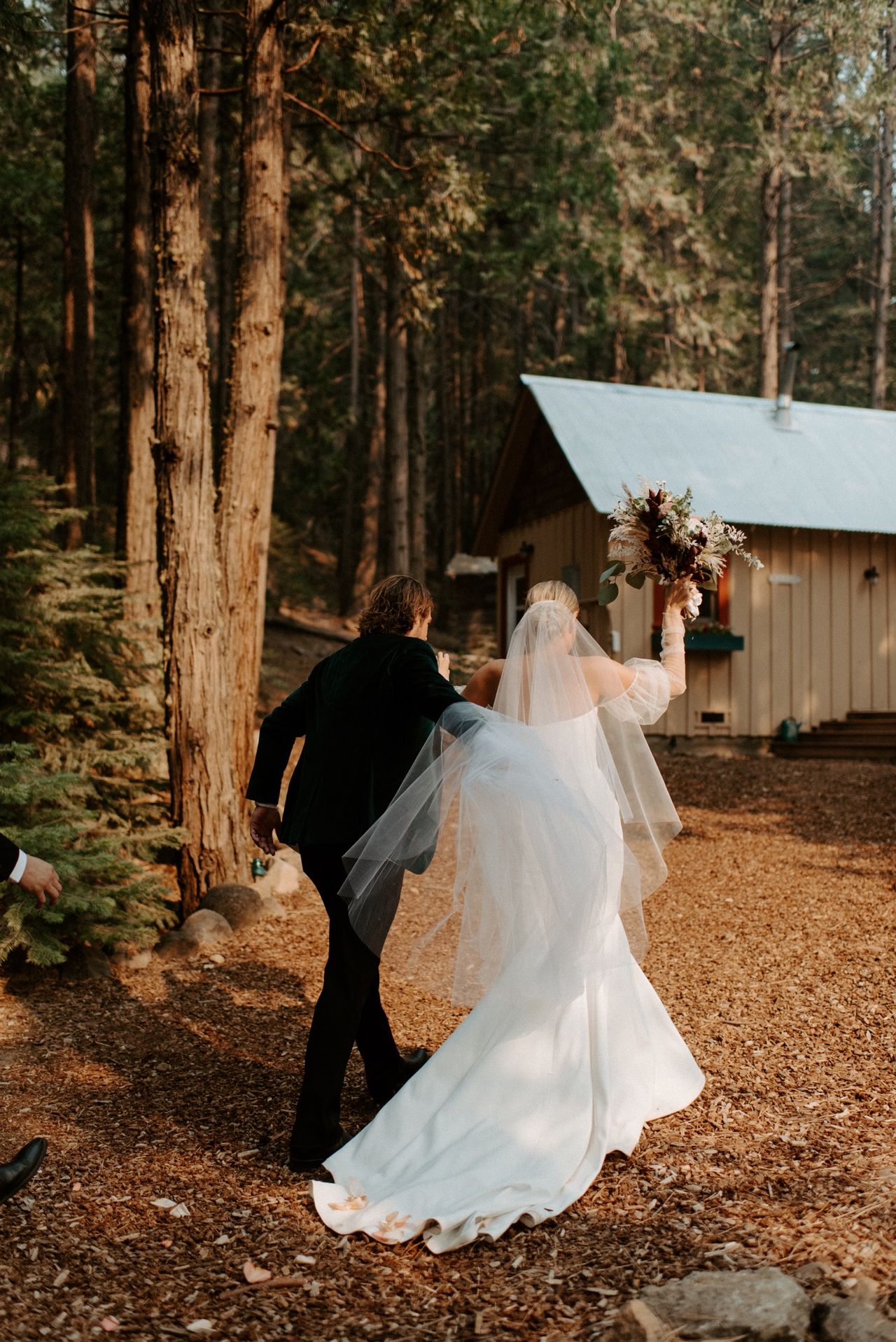 Kyle leads Joan toward a little cabin after the ceremony