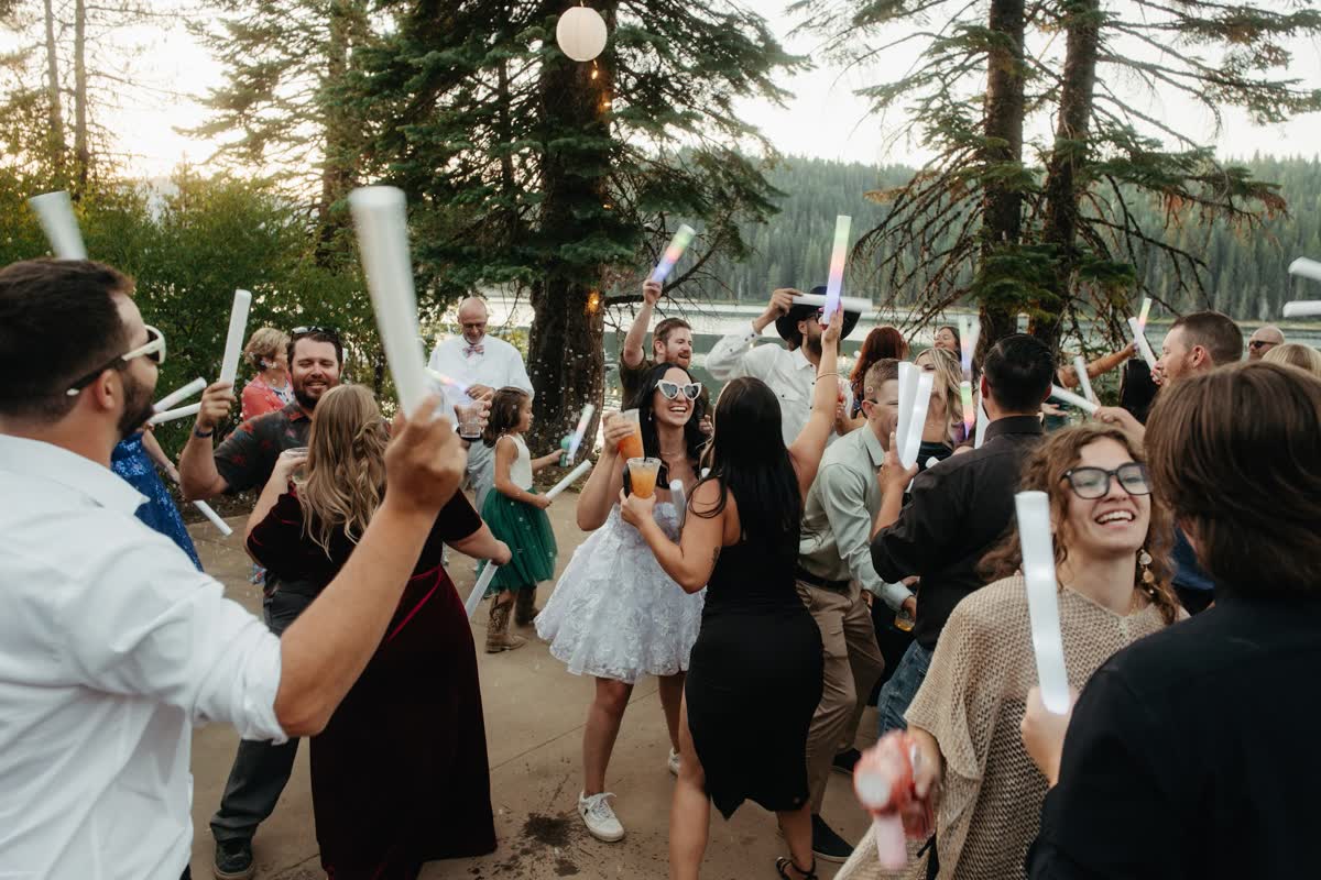 Guests dancing with glow batons under the pines at Bucks Lake
