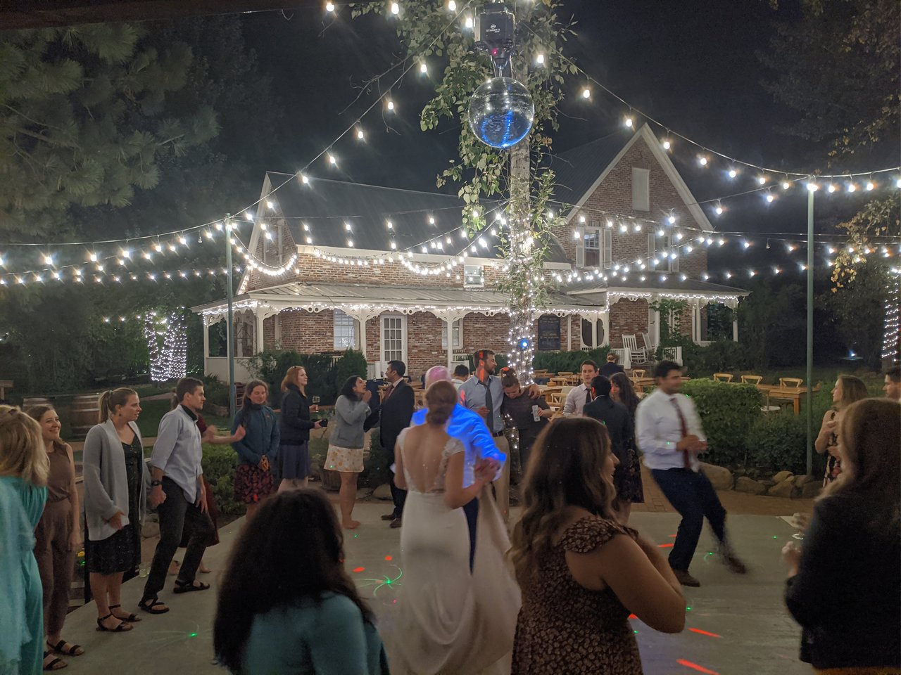 Lauren dances under the disco ball with her friends around her